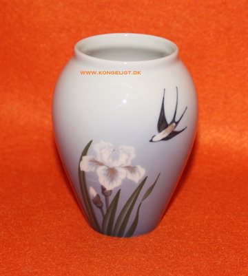 Vase med svale og blomster